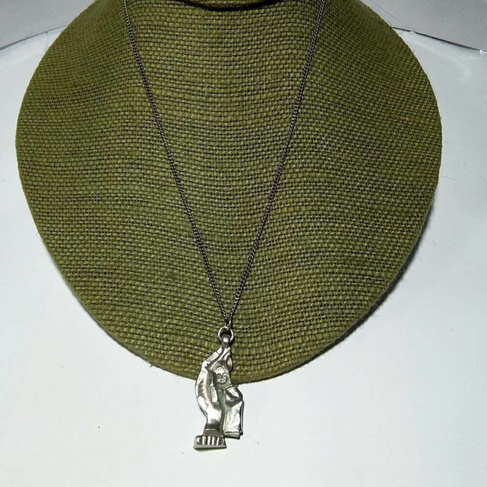 Women`s silver tone pewter figural woman necklace.